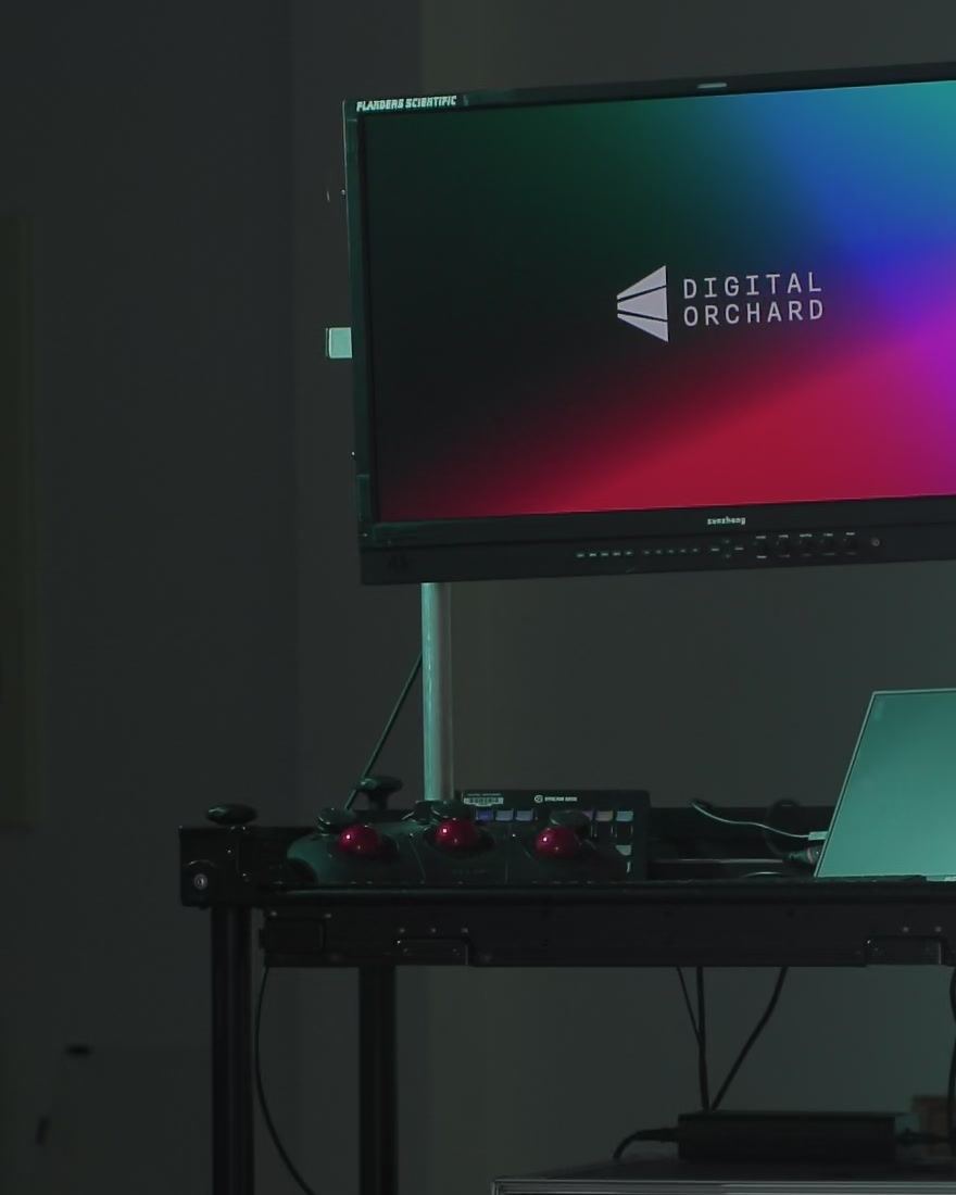 Grading station with a reference monitor and control panels.
