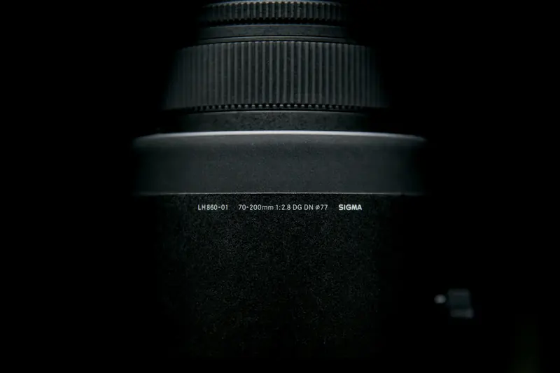 Sigma 70-200mm f/2.8 DG DN Sports lens for L-Mount, lit on black